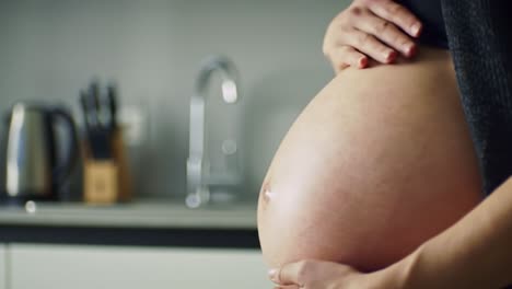 pregnant woman caressing her belly