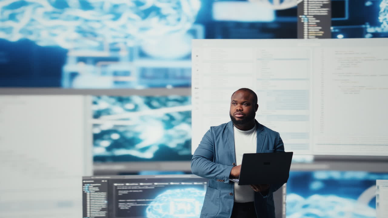 Black IT engineer working in a digital environment with programming language