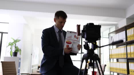 businessman presenting data and charts during an online video recording