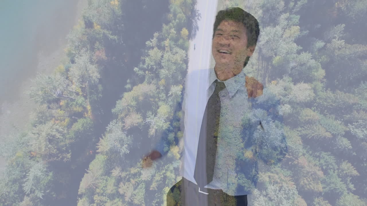 Dancing man in suit over animation of lush green forest, smiling happily