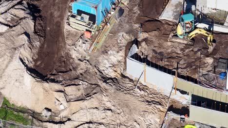 drone footage captures construction workers and machinery at a building site in gold coast, australia, under bright daylight