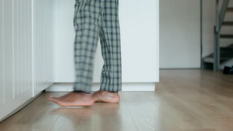 man in pajamas walking and getting ready in the morning