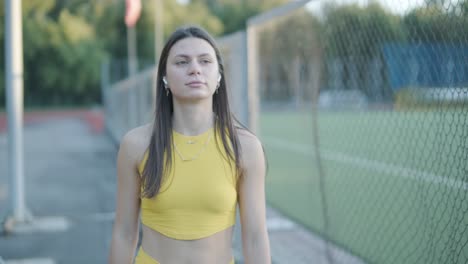 female athlete running on outdoor track in sportswear