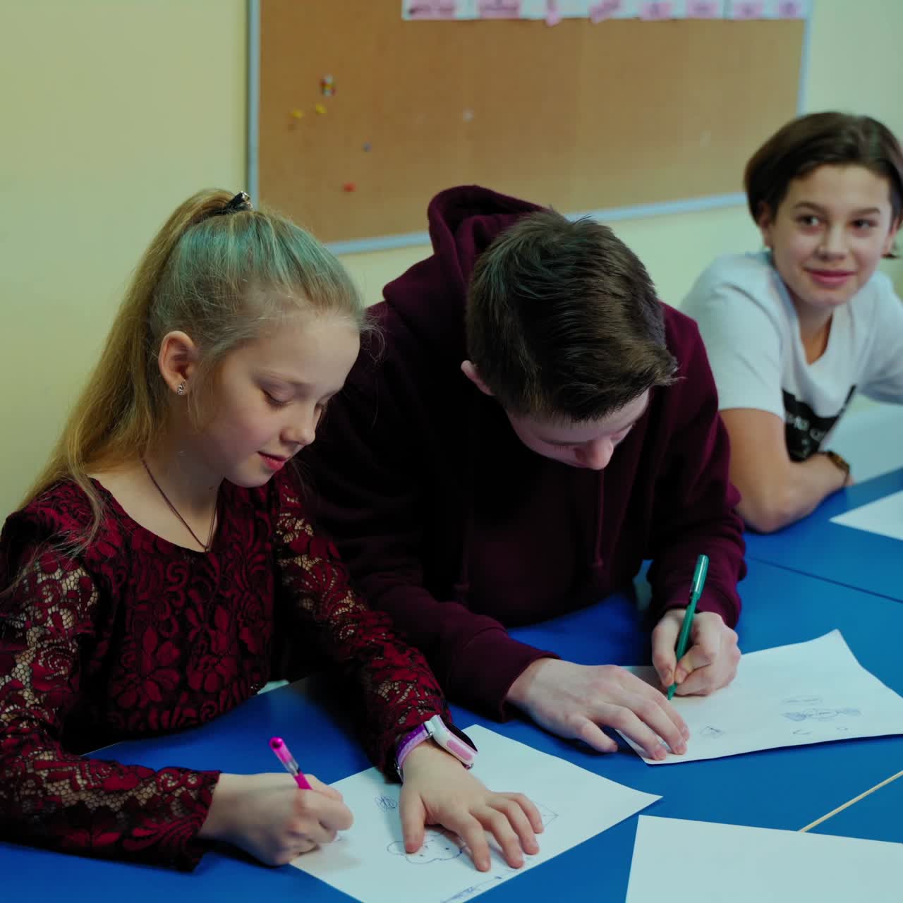 Students in the classroom. Teenage boy raising up his hand and goes to the board. Clever boy ready to answer during the lesson. Learning process at school.