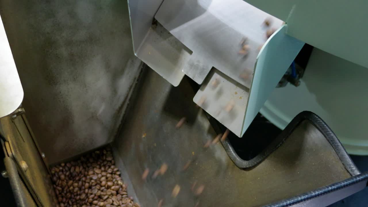 Witness the intricate process of coffee production showcasing raw beans transforming into a delightful drink.