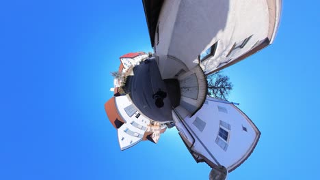 little tiny planet 360 small world view of a man walking urban citywide in 4k