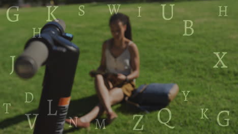 animation of letters over biracial woman with scooter reading in park