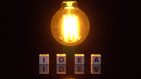 creative and success concept , bright ideas light bulb invention or idea . symbol of idea. the light comes on on a black background