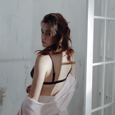 woman in pink robe and lingerie