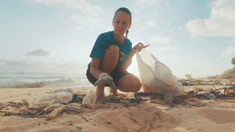 caucasian woman volunteer fights climate change by cleaning ocean of garbage