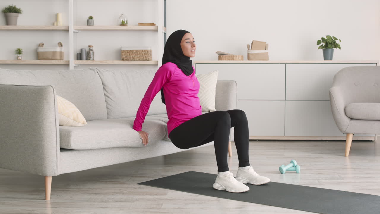 Woman doing home workout on a couch