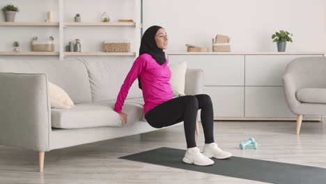 woman doing home workout on a couch