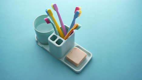 Ful-toothbrushes-in-white-mug-against-a-wall