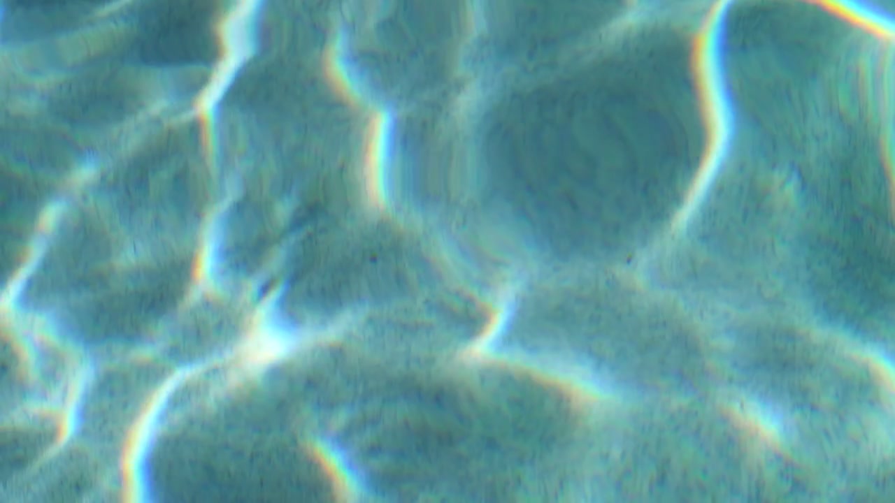 Shot in 1080p, 120fps. A macro shot of rippling pool water.