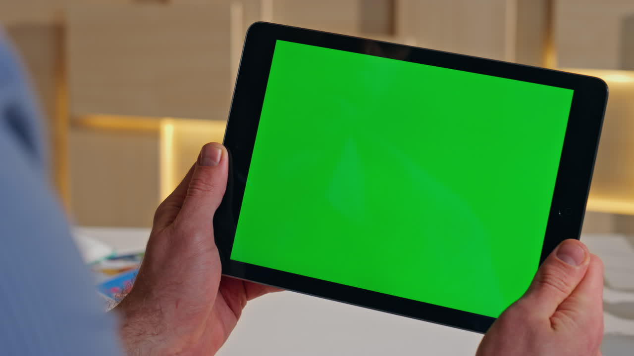 Company worker looking greenscreen tablet browsing video in office close up.