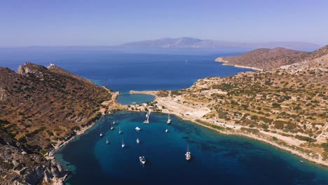 aerial: marina on aegean sea with sailboats and yachts on sunny day