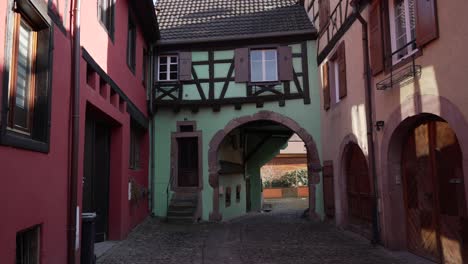 empty cobblestone street with colourful half timbered houses in kaysersberg, france