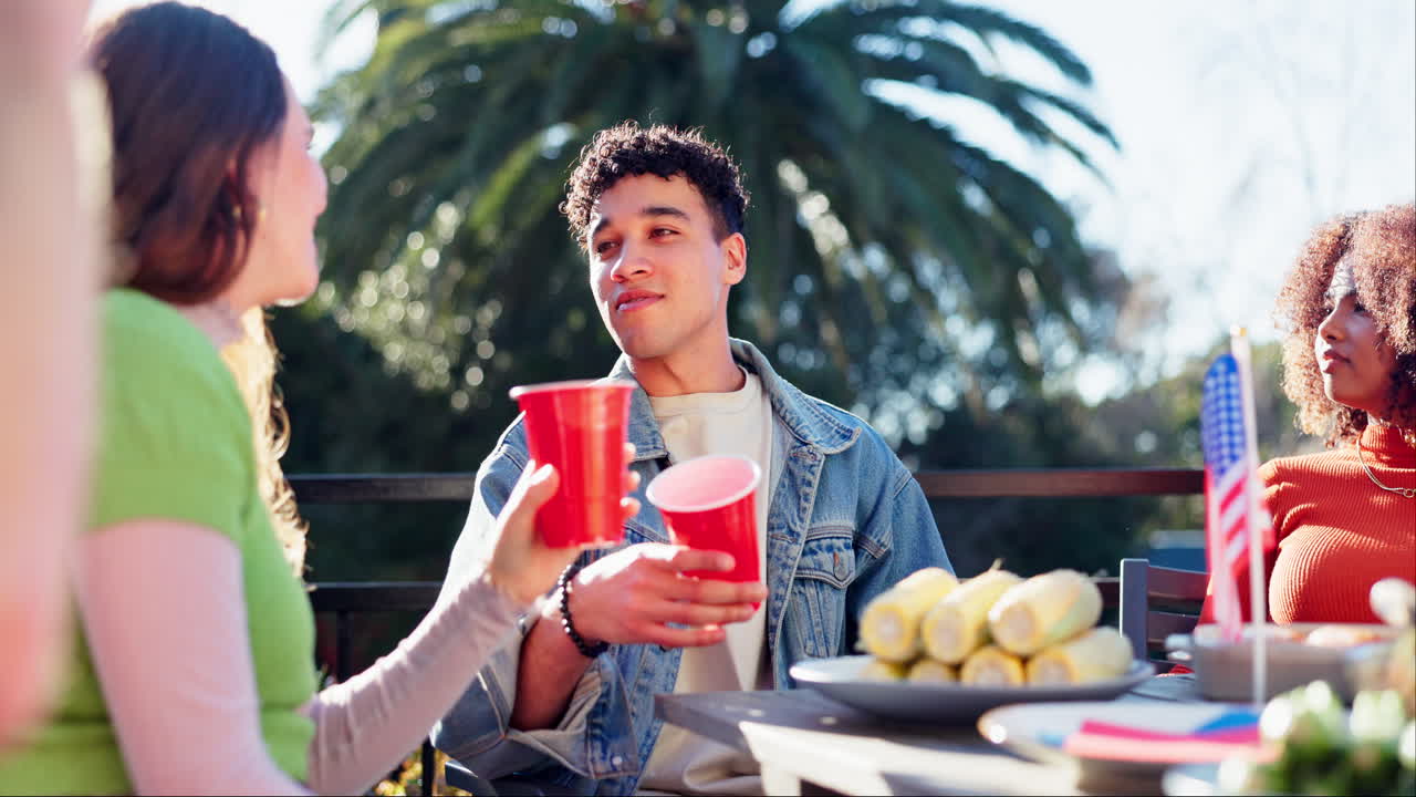 Friends celebrating with red cups at an outdoor gathering