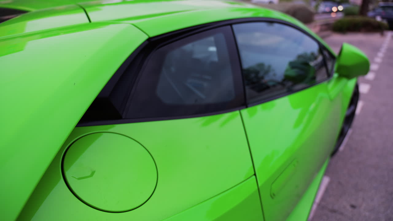 Close up of the side of a lime green car on the street