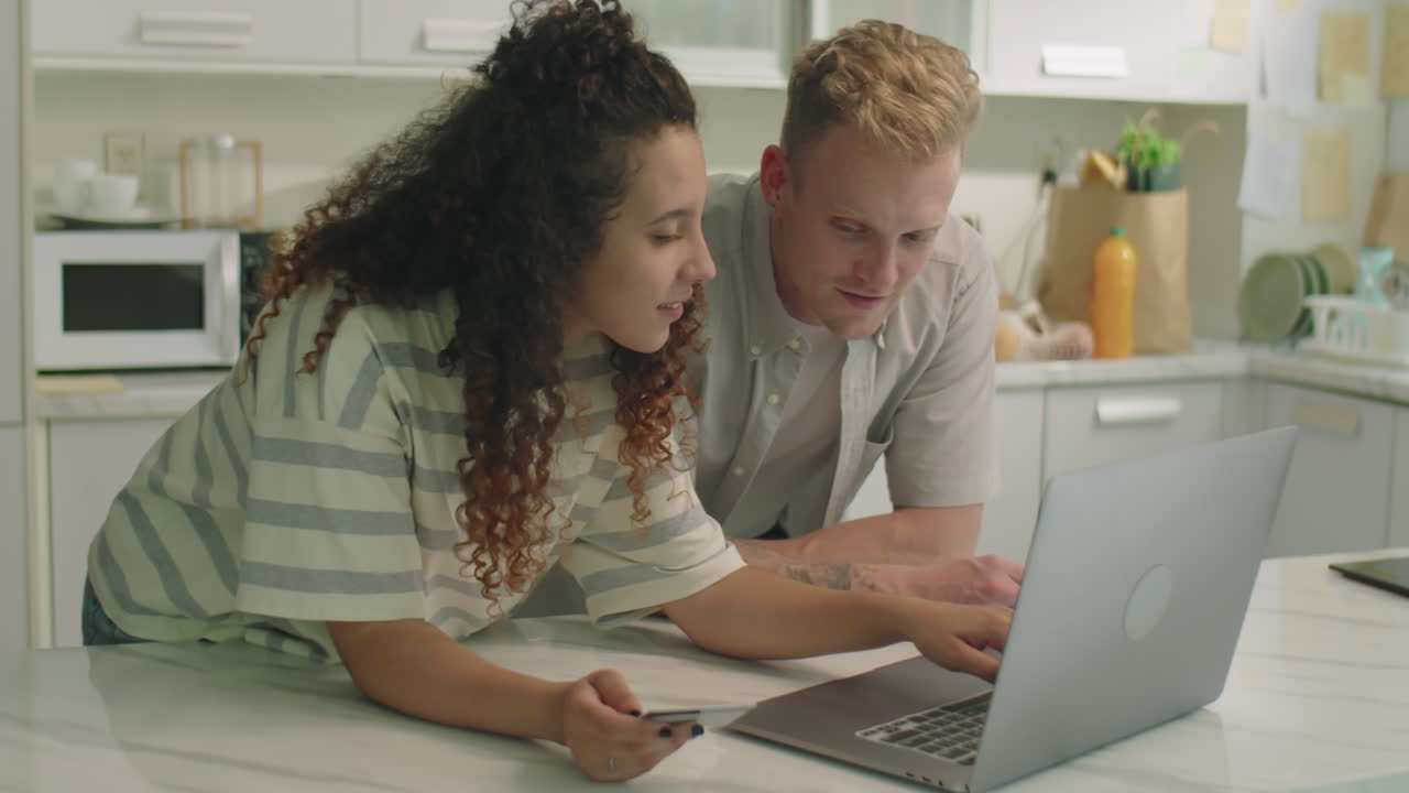Couple Doing Online Shopping with Laptop at Home