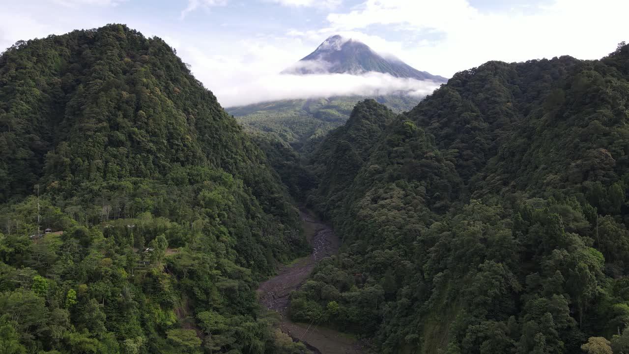 Beautiful view of Mount Merapi in the morning between the green hills