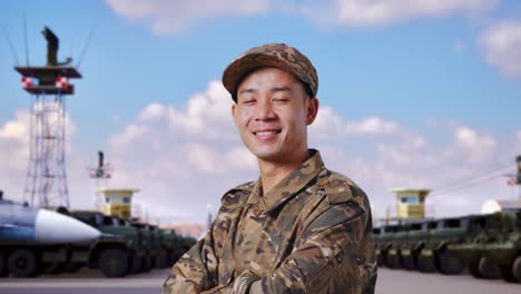 smiling asian soldier in camouflage uniform