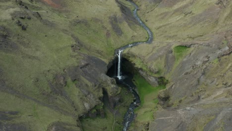 Stunning-view-of-famous-Kvernufoss-waterfall-in-rugged-landscape-of-Iceland