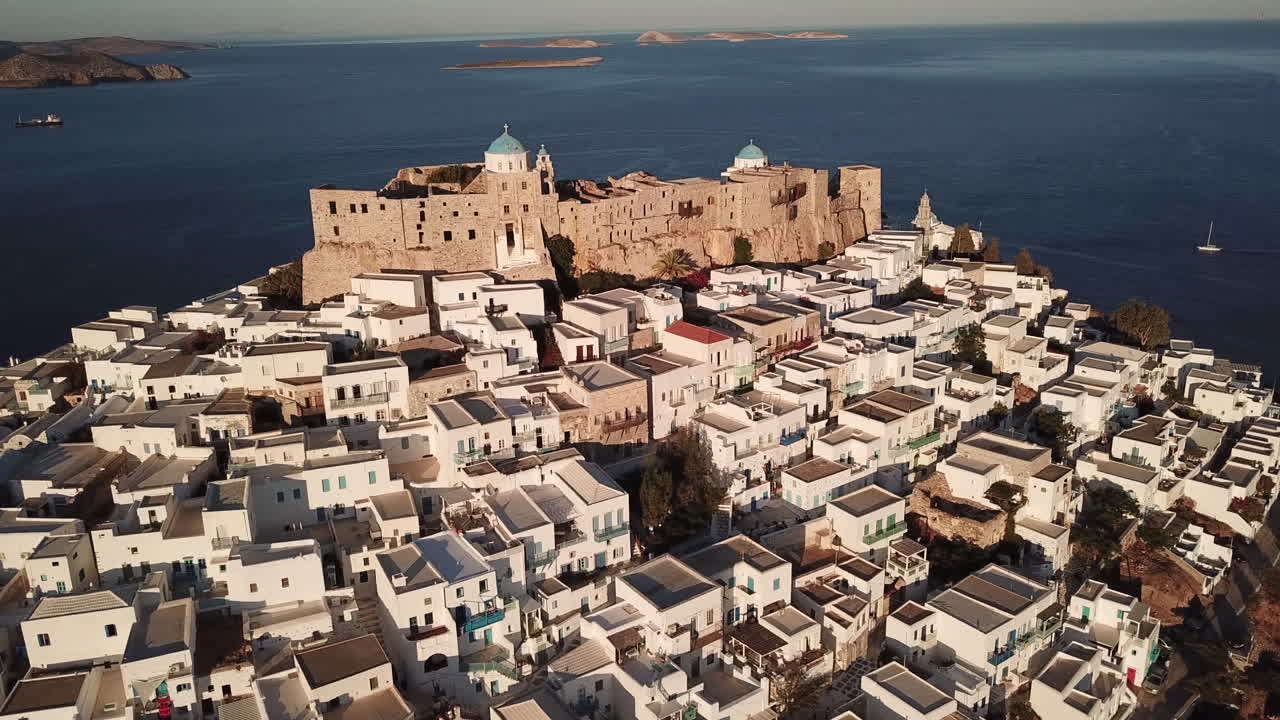 Castle of Astypalea,4K aerial footage of Querini Castle during golden hour.Footage zooms out from a perfect angle where you can see the blue domes and than footage slightly turns from right to left.