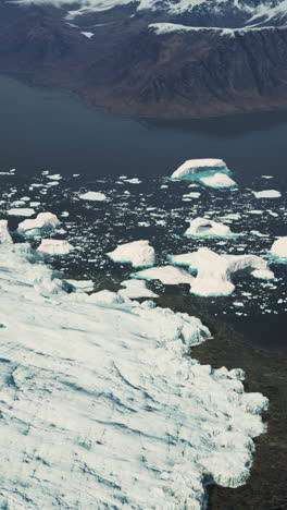 aerial view of glacier and icebergs in greenland