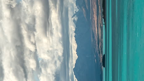 vertical timelapse of clouds moving over mountain, lake pukaki, new zealand