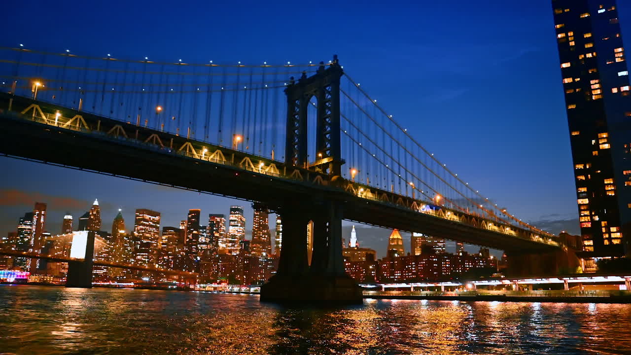 Manhattan Bridge skyline at night. Manhattan Bridge stands illuminated at night, showcasing the vibrant skyline of New York City across the water