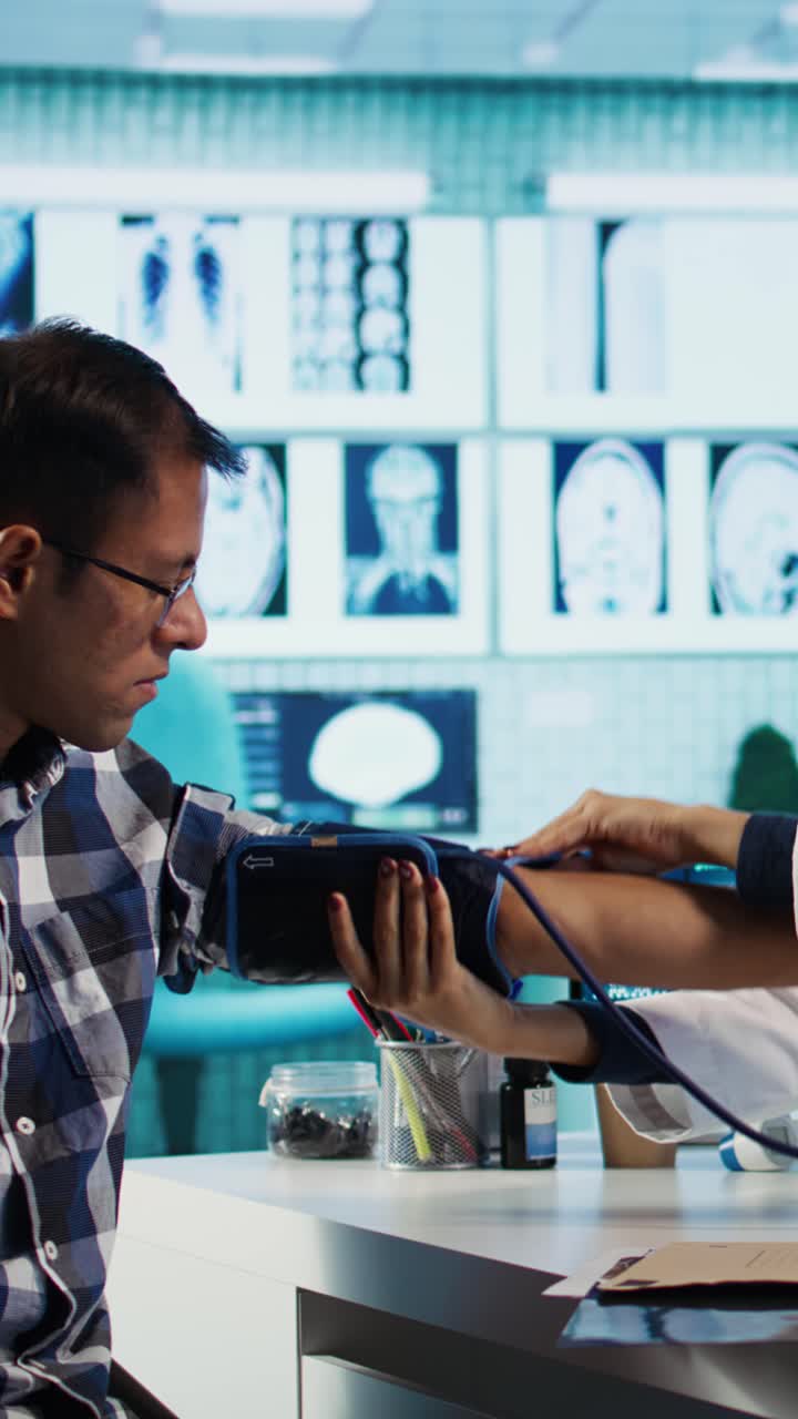 Female Doctor Measures Patient's Blood Pressure During Medical Checkup