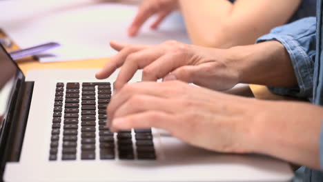 hands typing on a laptop