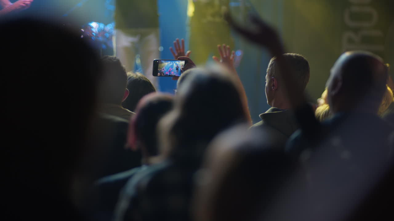 Pubblico che registra un concerto dal vivo con smartphone
