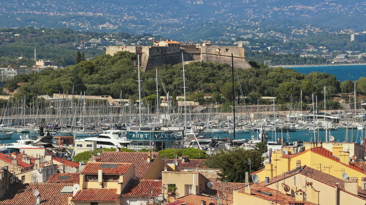 Aerial drone view of Fort Carre, Antibes, Francethe 16th-century fortress, with sailboats in the marina and mountains in the background