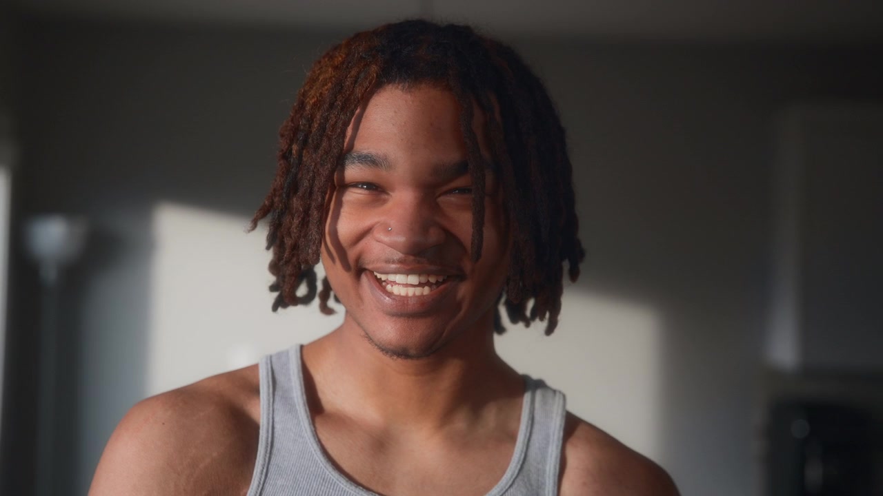 Portrait of a young adult male laughing at sunset