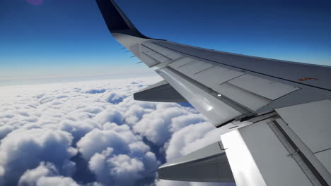 airplane window view of fluffy clouds
