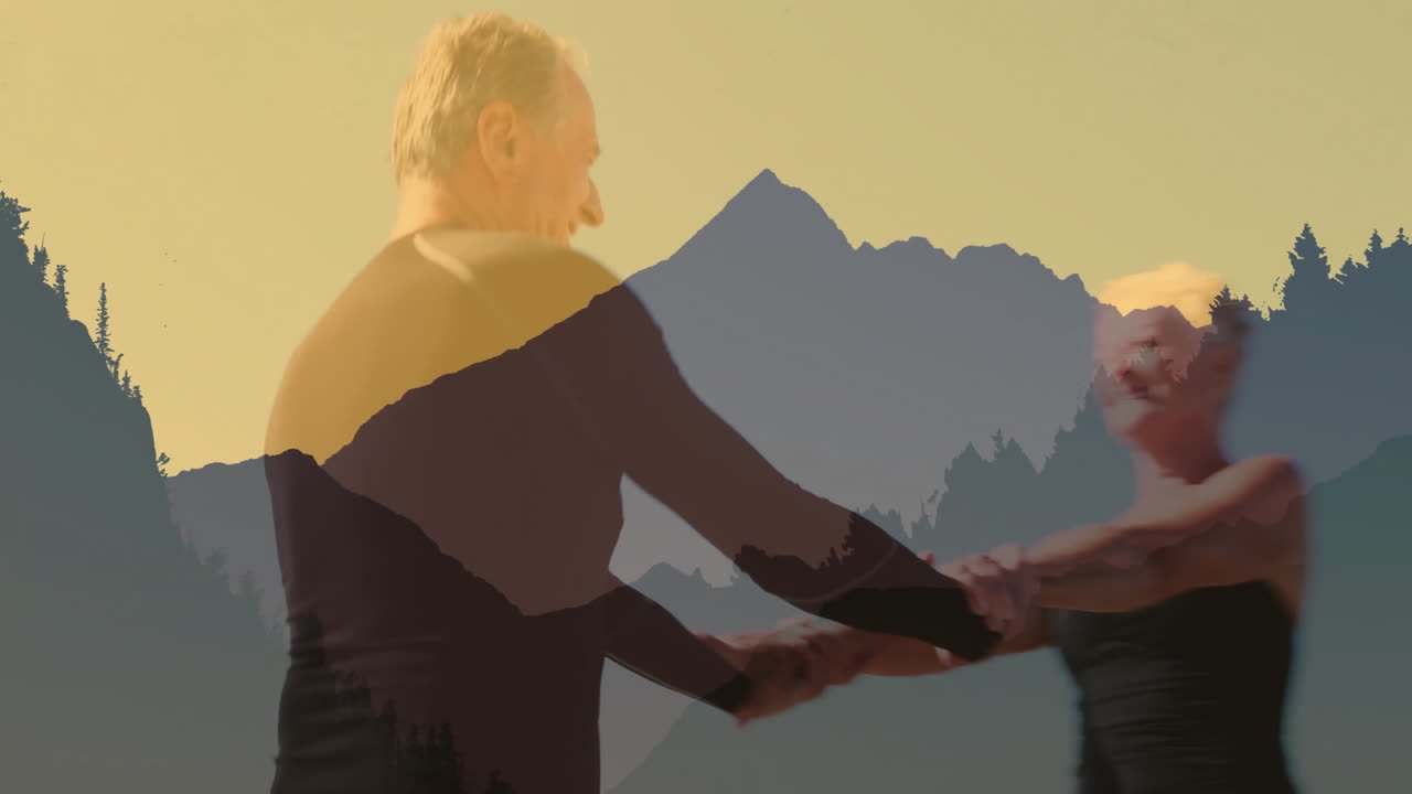 Dancing over scenic mountain landscape at sunset, two people enjoying animation