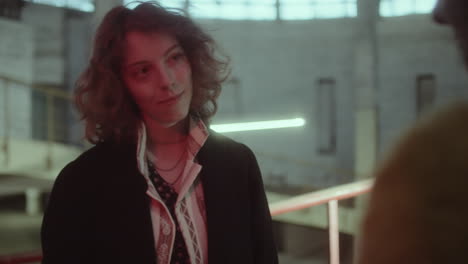woman with curly hair in a moody industrial setting