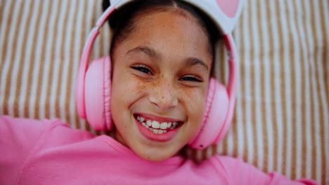 girl smiling with pink headphones