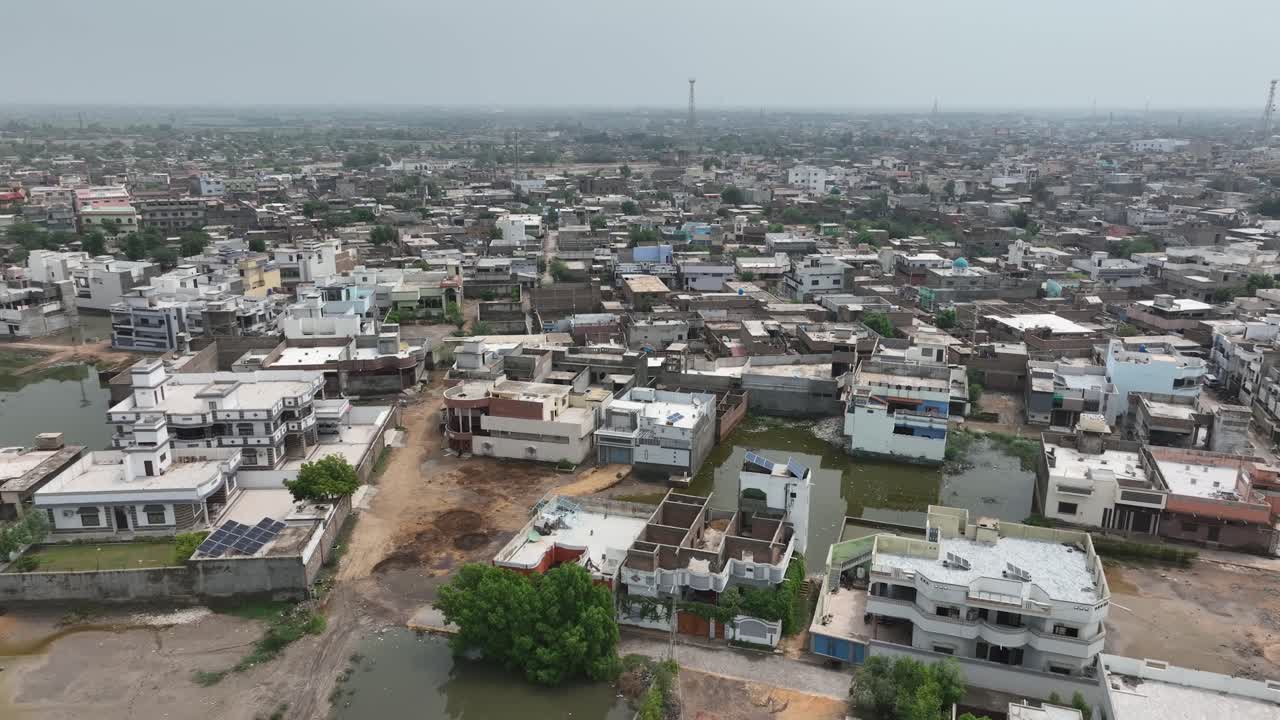 Drone descended and tilting up to show the beautiful city of Badin in Pakistan with clear skies