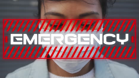 animation of text emergency, over woman wearing face mask in city street