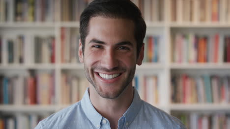 portrait-attractive-young-man-smiling-cheerful-enjoying-successful-lifestyle-happy-independent-male-in-bookshelf-background