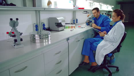 scientist team working in research lab. laboratory technicians using tablet pc