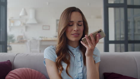 closeup business woman speaking on phone at home office. recording voicemail.