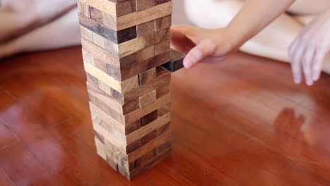 player carefully removing a wooden block