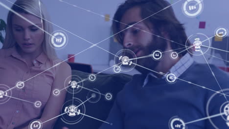 Animation of media icons over caucasian business people talking