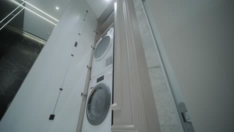 modern laundry room with stacked washer and dryer