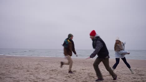 friends having fun on a winter beach