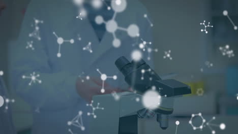 Molecular-structure-animation-over-scientists-working-with-microscope-in-laboratory